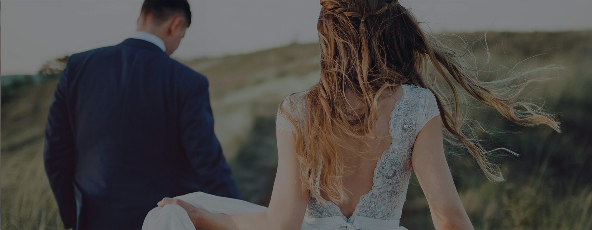 Bride and groom walking through a farm