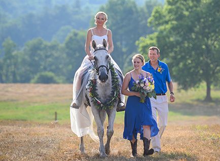 Bride riding to wedding on a horse